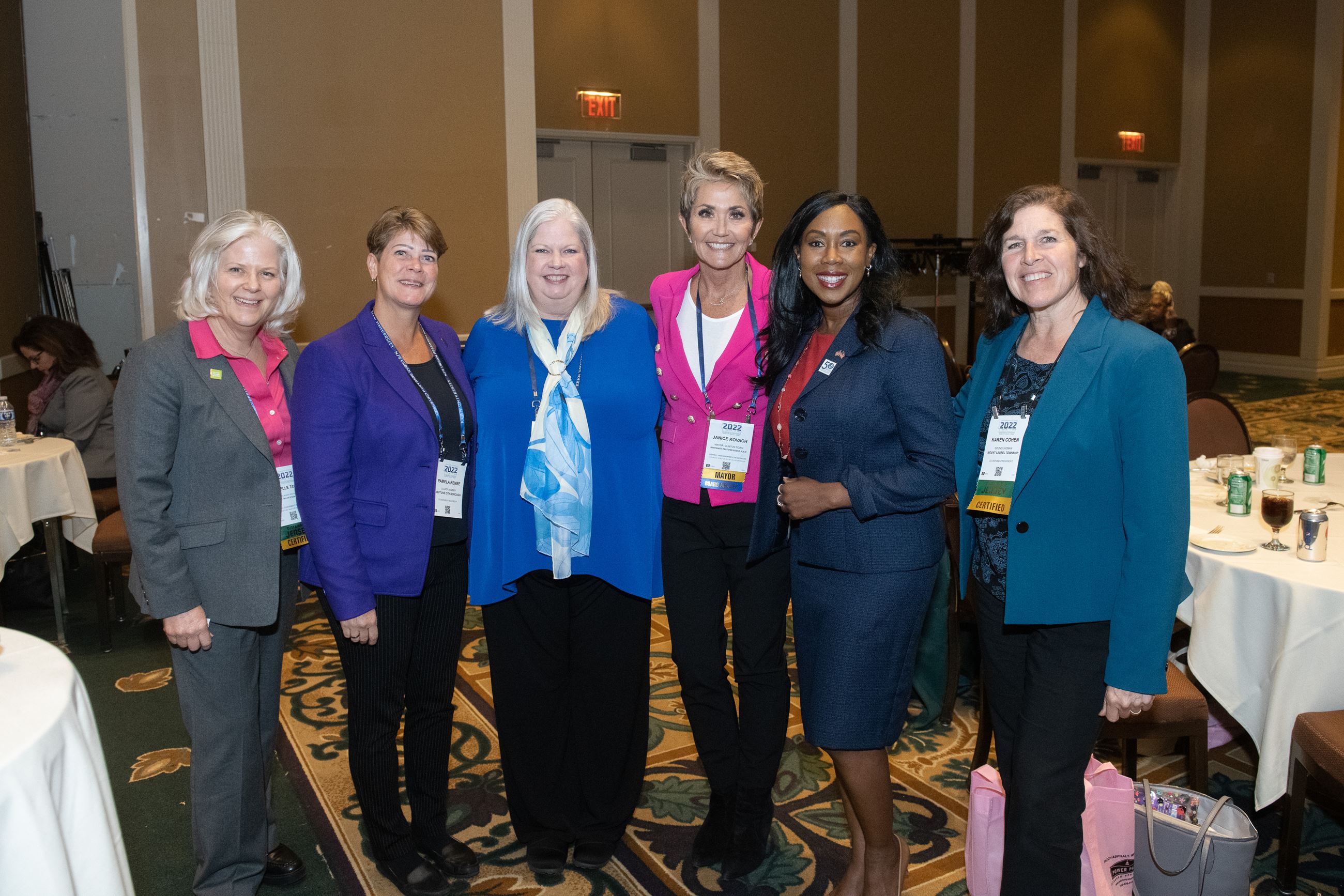 Six women smile standing in a row of the WIMG event